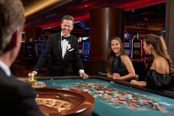 A close-up shot of golden coins falling around a spinning roulette wheel, representing immersive casino action at 786BD.